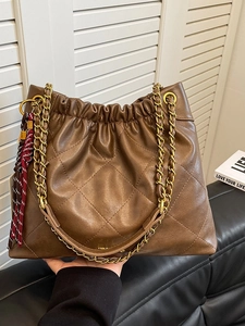 Chic dark brown quilted tote bag with chain strap and drawstring closure for women