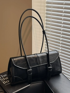 Elegant black waxed leather baguette shoulder bag with double buckle straps and retro style