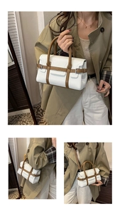 Close-up of white pebbled leather handbag with brown handles and versatile carrying styles