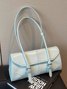 Light blue oil wax leather baguette bag with dual shoulder straps and metal buckle accent