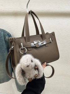 Brown litchi grain leather handbag with metal turn-lock and cute bunny pendant