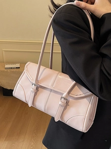Pink waxed leather baguette bag with dual buckle straps and long shoulder handle
