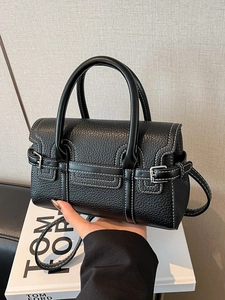Elegant black lychee grain leather handbag with white contrast stitching and silver hardware