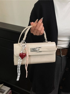 Sac baguette rectangulaire beige avec fermoir argenté et charmant pendentif cœur rouge
