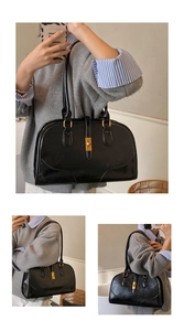 Details der schwarzen Vintage-Boston-Tasche mit goldenem Drehverschluss und Schultergurt