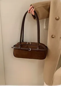 Detail of dark brown matte suede Boston bag featuring silver buckle and zip closure