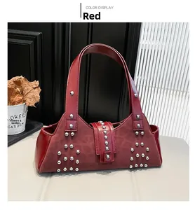 Detail of red leather underarm bag with silver studs and leopard pattern embossing