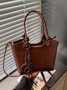 Brown faux leather tote bag with letter embossing and knotted handle detail