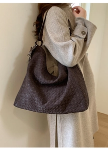 Detail view of large dark chocolate woven leather hobo bag with wide shoulder strap