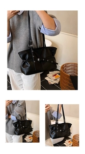 Détails du sac cabas en cuir noir avec sangles enveloppantes et œillets métalliques
