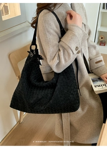 Close-up of black woven leather tote bag with Intrecciato pattern and large capacity