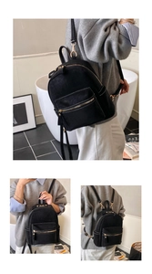 Detail view of mini black faux suede backpack with gold hardware in casual daily use