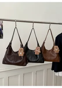 Three minimalist large-capacity hobo tote bags in brown and black with bear charms