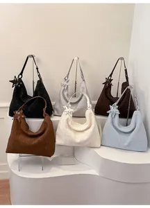 Detailed row of woven hobo tote bags in six colors with star charms and adjustable straps