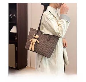 Brown herringbone tote bag featuring high-quality texture and a cute knitted bear charm
