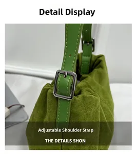 Detail of adjustable green shoulder strap with silver buckle and fine stitching