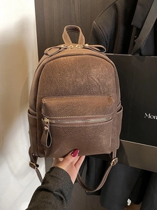 Brown vintage faux leather backpack for women with decorative bow and litchi texture