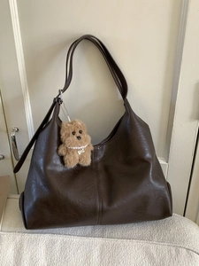 Brown vintage large capacity faux leather tote bag with a plush dog pendant and shoulder straps