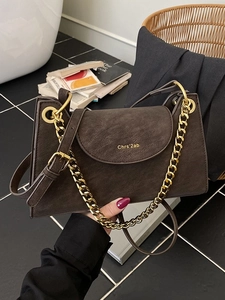 Dark brown suede chain crossbody bag with a geometric trapezoid design for women