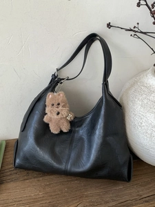 Minimalist black hobo shoulder bag in faux leather with a cute plush puppy charm