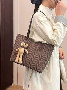 Vintage brown herringbone tote bag for women with a cute knitted bear charm on shoulder
