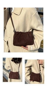 Close-up of coffee brown suede bucket bag featuring pleated cloud texture and silver hardware