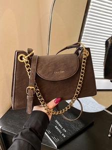 French style brown leather crossbody bag with chunky gold chain strap and flap closure