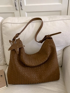 Deep brown hand-woven leather hobo bag with large capacity and star charm detail