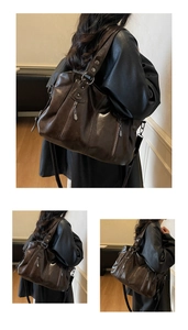 Detail of dark brown oil wax leather tote bag with vintage metal zippers and rivets
