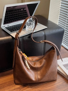Brown leather hobo shoulder bag with wooden bead charm and adjustable strap for women