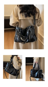 Detailed views of a black retro tote bag with multiple zippers and adjustable strap