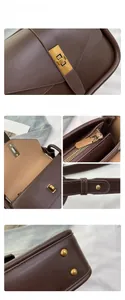 Dettaglio borsa in pelle marrone con fibbia dorata vintage, zip e piedini protettivi fondo