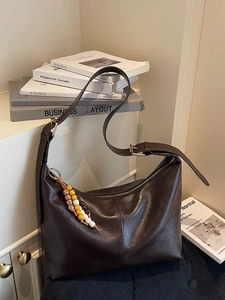 Deep brown faux leather hobo shoulder bag with colorful beaded charm and wide strap