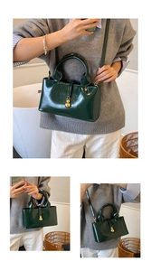 Detail of dark green glossy leather bag featuring iconic golden twin ball clasps
