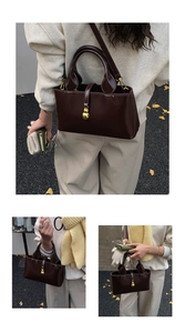 Detail of glossy dark brown bucket bag with gold gourd charm and semi-circular handle
