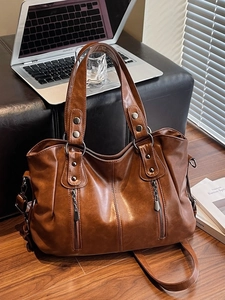 Vintage brown large capacity PU leather tote bag with shoulder strap in office setting