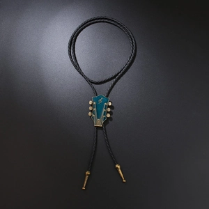 Vintage bolo tie with guitar head slider, teal enamel inlay and golden g-clef symbol