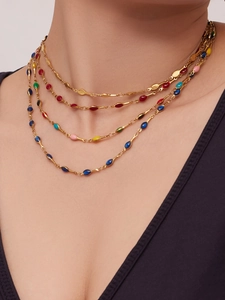 Detailed view of layered 18K gold plated necklaces with colorful enamel teardrop pendants