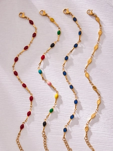 Detail of minimalist stainless steel bracelets with colorful enamel teardrop pendants
