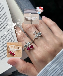 Detail shot of S925 silver rings set with cherry motif and red ruby gemstones
