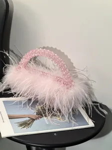 Detail of pink ostrich feathers and transparent beads on this elegant evening handbag