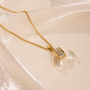18k gold plated stainless steel crescent moon pendant necklace on silk background