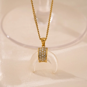 18k gold plated moon pendant necklace with frosted resin and zircon on silk background