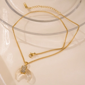 Macro view of 18k gold plated moon pendant with resin and sparkling zircon details