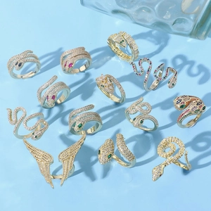 Luxe cobra rings set with sparkling zircons on a stylish light blue background
