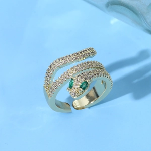 Luxurious gold cobra snake ring with sparkling white zircon stones and green gem eyes