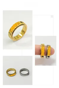 Detail of 6mm rotating fidget ring showing matte cross engraving and gold silver finish
