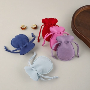 Velvet drawstring jewelry pouches with scallop edges in five vibrant assorted colors