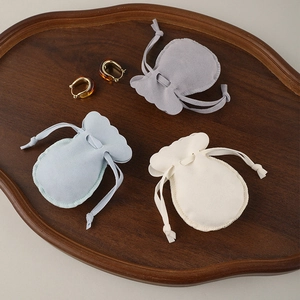 Three premium microfiber drawstring jewelry pouches in grey, light blue and beige colors