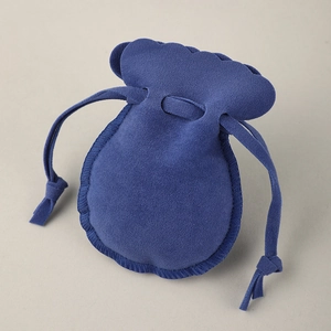 Dark blue velvet jewelry pouch with elegant petal-shaped wavy edges and drawstring closure